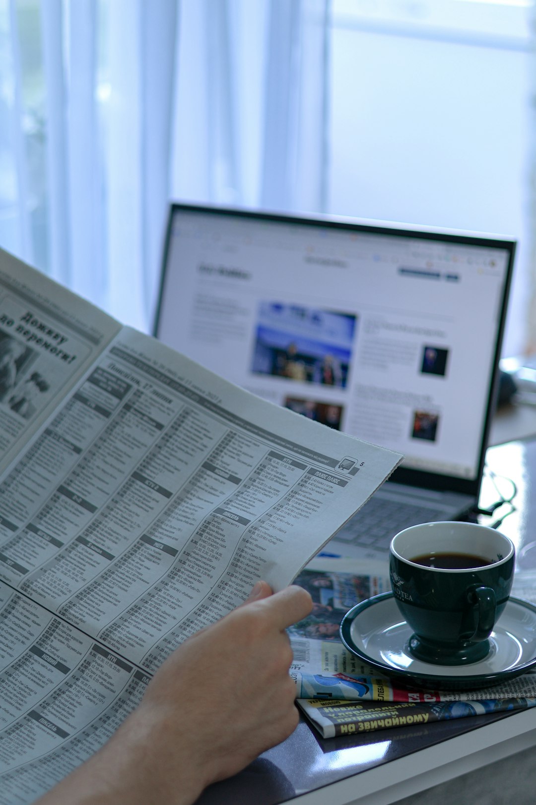 a man reads the morning news over a cup of coffee